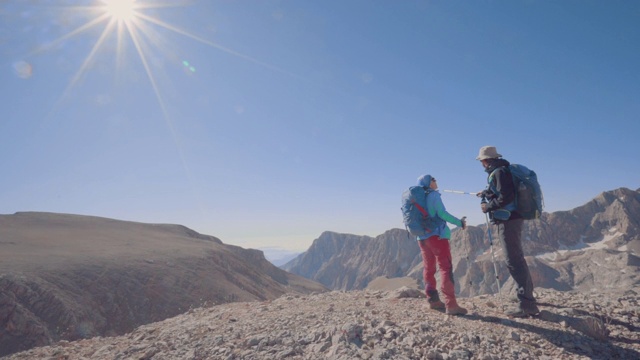 登山队长在山顶给队友指路视频素材