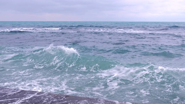 强烈的暴风雨海浪拍打着海滨的防波堤。视频素材