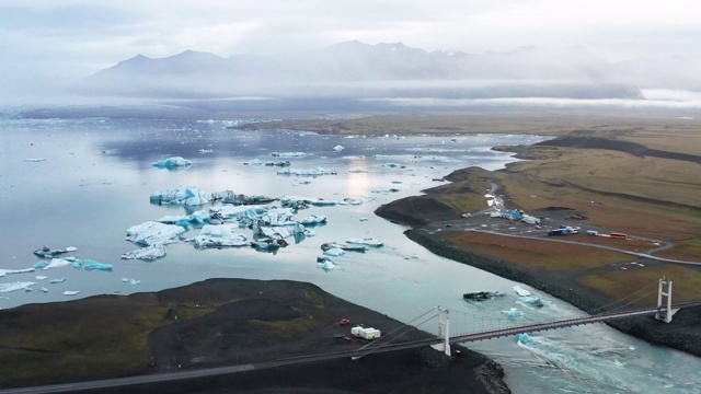 4K鸟瞰图缩放镜头冰山在Jokulsarlon礁湖与戏剧性的云视频素材