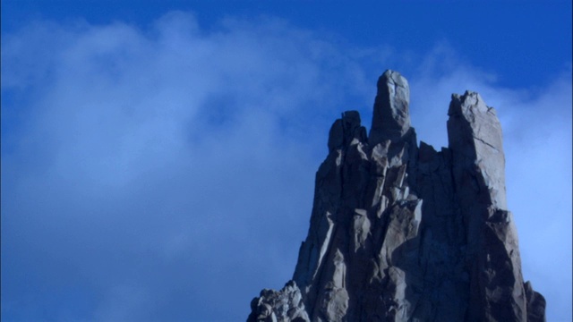 云朵飘过岩石嶙峋的山峰。视频素材