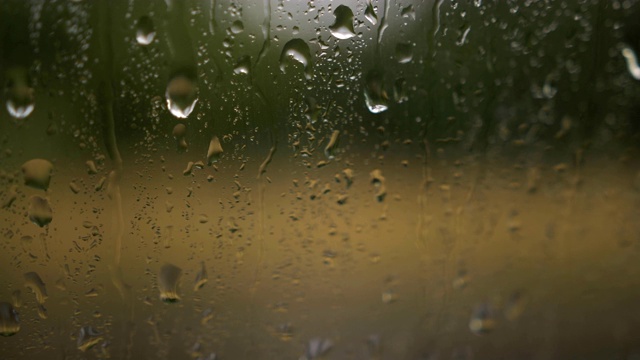 雨点落在有云背景的窗玻璃上。雨滴的自然模式。在雨中开车。从车窗往下看视频素材