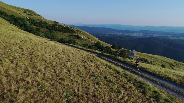 成年女子在山路上慢跑视频素材