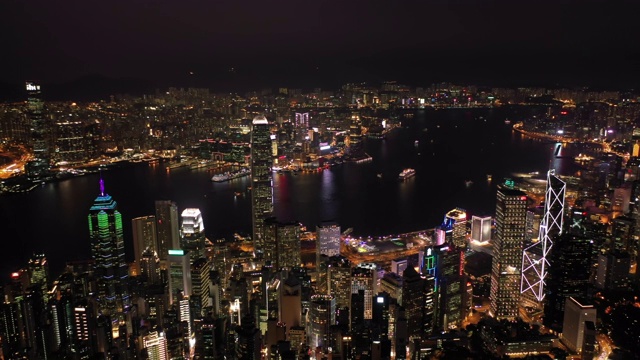 无人机夜间鸟瞰香港城市景观。紧密的空中向前射击飞过办公大楼和摩天大楼。视频素材