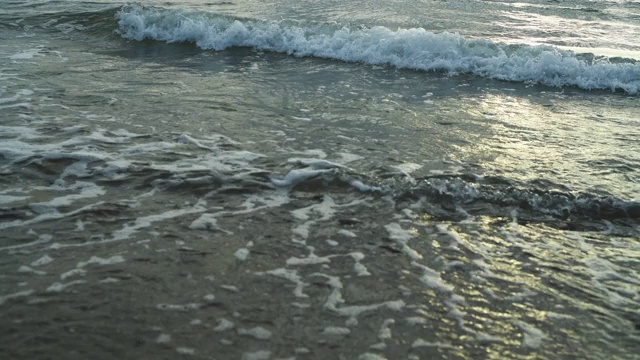 日落时海浪拍打着海岸视频素材