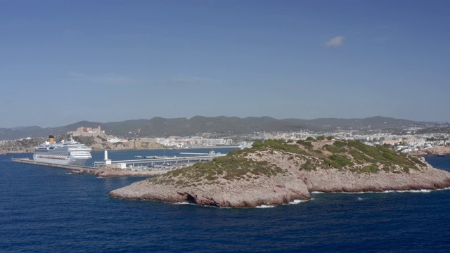 航拍:西班牙伊比沙岛，天空湛蓝，接近海面上的岩层视频素材