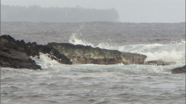 海浪冲击着布满岩石的海岸线。视频素材