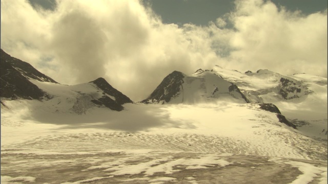 云朵漂浮在雪山之上。视频素材