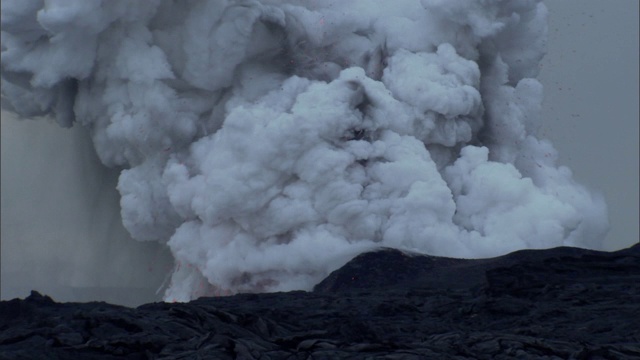 炽热的岩浆从冒纳克亚火山喷口喷出的蒸汽和火山灰中喷发出来。视频素材