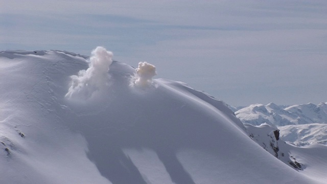 两次爆炸引发了雪山顶部附近的雪崩。视频素材