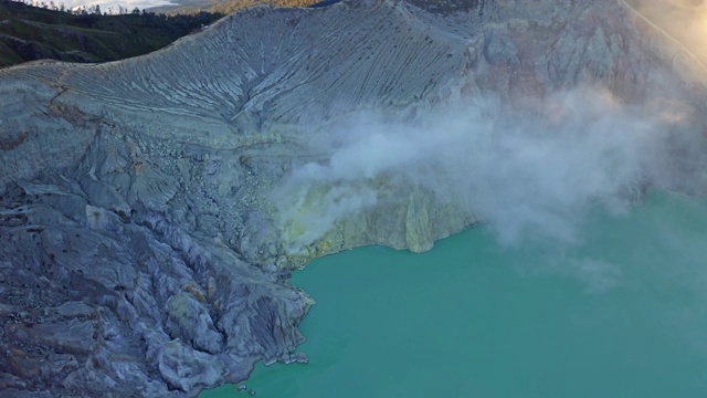 鸟瞰图的岩石悬崖在卡瓦伊真火山与绿松石硫水湖在日出。全景在东爪哇，印度尼西亚。自然景观背景。视频素材