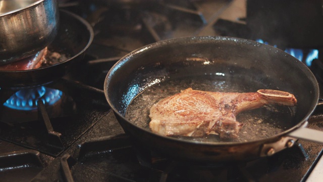 一位专家在平底锅里煮猪肉排视频素材