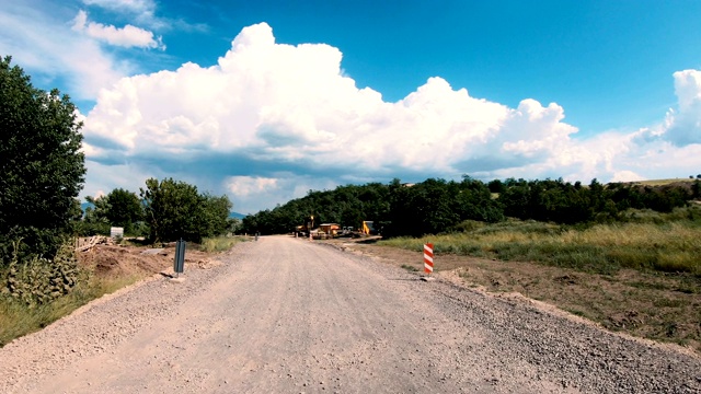 在砾石乡郊道路上驾驶并进行道路工程视频素材