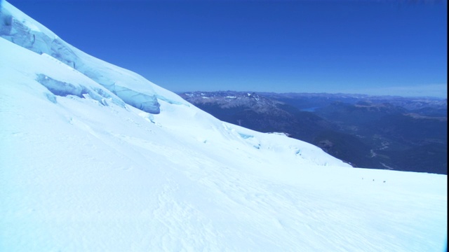 一支登山队艰难地爬上一座雪山。视频素材