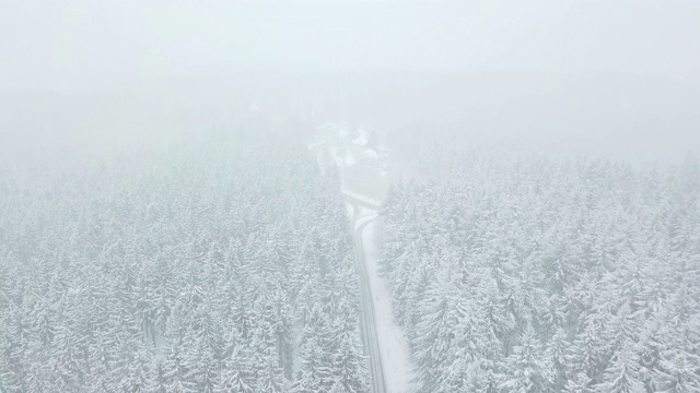 航拍:飞越德国Taunus森林美丽的白雪森林街道视频素材