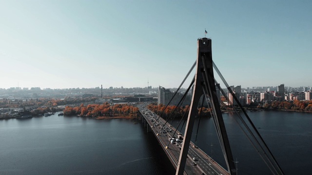 大城市桥上繁忙的汽车交通。高层建筑和植物背景。市中心繁忙的城市步行街。钢绳牵引混凝土桥。空中无人机视图。基辅,乌克兰视频素材