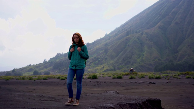 日出时在布罗莫火山附近散步的女人视频素材