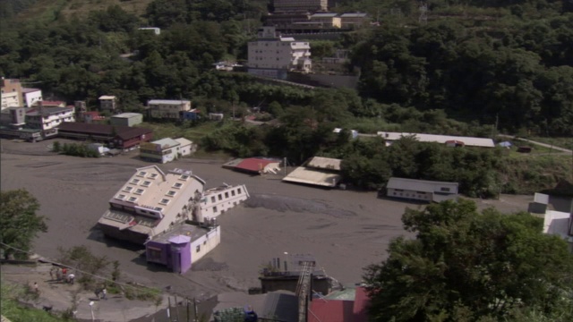 飓风过后，一幢被掀翻的建筑躺在泥泞的街道上。视频素材