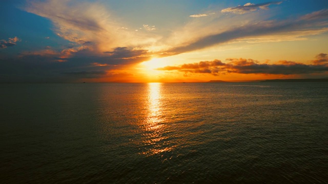 在一个愉快的夏天晚上的海景:美丽的日落，彩色的云，一个纯海与游艇，在水面上闪烁的太阳。海洋，海洋，自然视频旅游，度假和冥想的地点视频素材