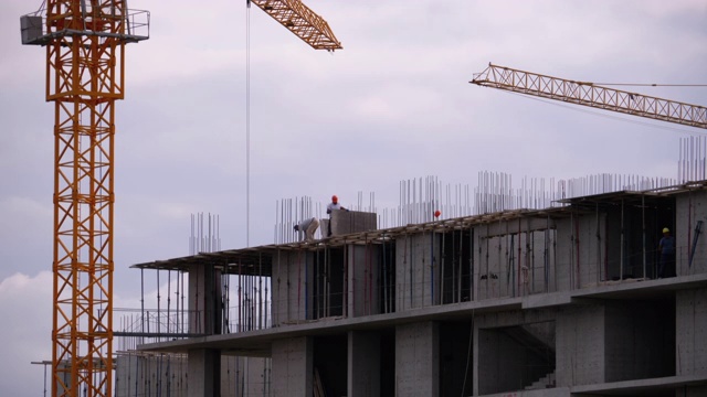 在建摩天大楼边缘的建筑商。建筑工地的工人视频素材