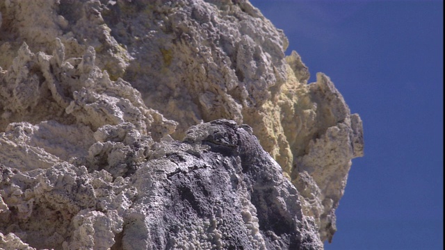 云层在布满硫磺沉积物的火山岩之上急速上升。视频素材