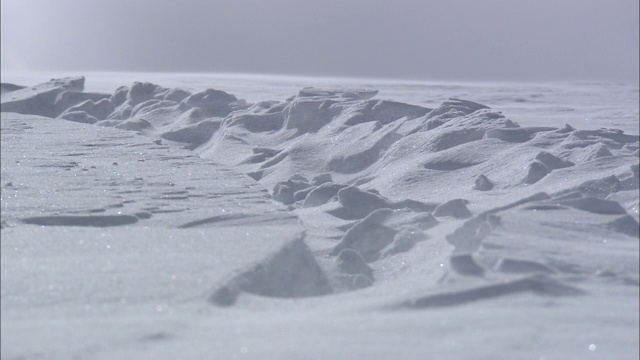 风吹过白雪覆盖的山。视频素材