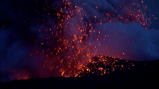 炽热的岩浆从冒纳克亚火山的火山口喷出的蒸汽和火山灰中爆发出来。视频素材