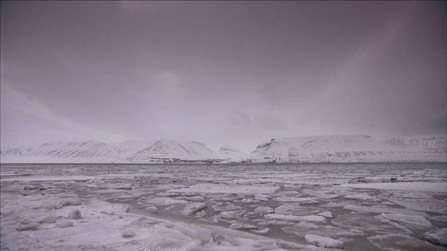 冰漂浮在雪山附近的湖面上。视频素材