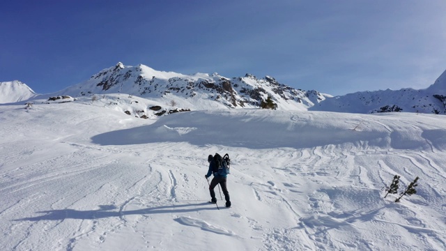 一个男人在雪山中徒步旅行视频素材