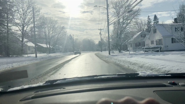 行驶在缅因州拉姆福德的道路上，刚下过雪，汽车从另一个方向驶来视频素材