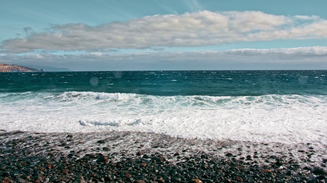 海上冲浪。海岸，碧绿的海浪和白色的泡沫。雨滴飞入相机，火山黑色的石头和沙子海岸视频素材