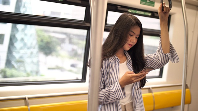 一名女性在地铁站使用智能手机视频素材