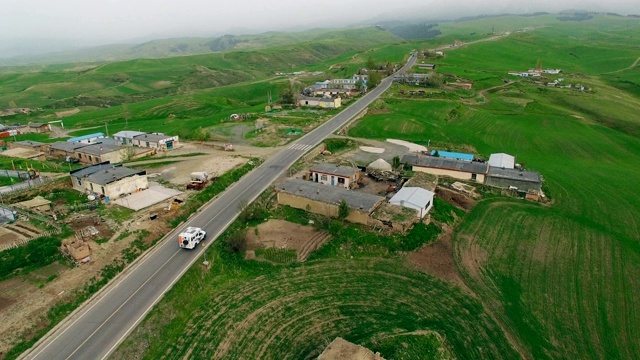 汽车在中国新疆的乡村道路上行驶的鸟瞰图。视频素材