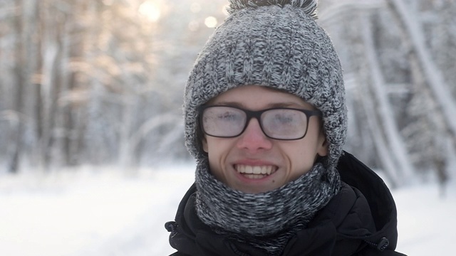 冬天雪地里戴着雾蒙蒙眼镜的人。编织帽子和围巾。视频素材