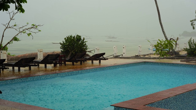 热带夏雨落在海边的游泳池视频素材