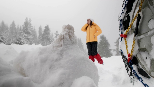 汽车观点。在雪地里开车。汽车在路上抛锚了。在恶劣的天气下，汽车会在偏僻的地方抛锚。汽车保险。一个女人在路上。视频素材