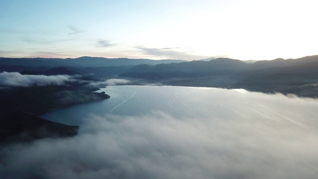 高空鸟瞰图的泸沽湖上空的云彩在中国日出视频素材