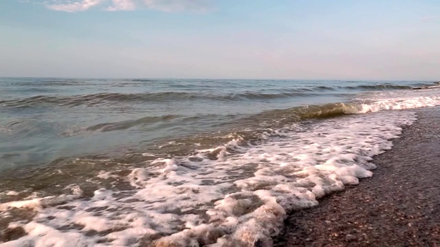 海滩，泡沫的海洋，海浪冲刷着沙子。海浪冲击着沙滩。海浪声视频素材