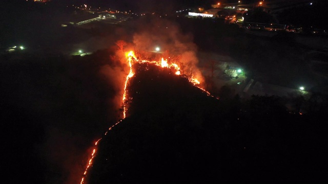 鸟瞰图移动向前野火和城市背景在夜间时间视频素材