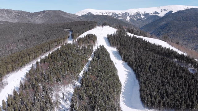 滑雪胜地的空中滑雪场与滑雪者和滑雪缆车。的雪山森林视频素材