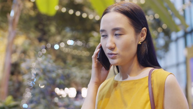 年轻的亚洲女人在餐厅打电话视频素材