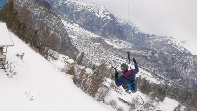 极限滑翔伞飞行员在雪天飞越瑞士阿尔卑斯山视频素材