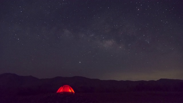 红色帐篷下的银河时间流逝南邦泰国，宇宙星系银河系时间流逝，黑暗的银河，银河视图，恒星线，时间流逝的夜空星星的天空背景。4 k。视频素材