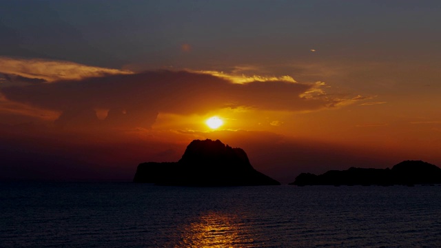 缓缓升起的太阳从海面和岛屿上缓缓升起。视频素材