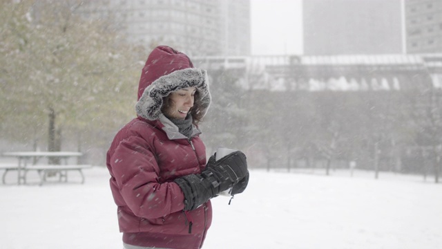 一个欧亚女人在下雪的冬天穿过公园视频素材