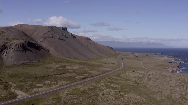 航拍露营车在道路上移动的山脉，无人机向前飞行的汽车景观由海洋-冰岛西南部，冰岛视频素材