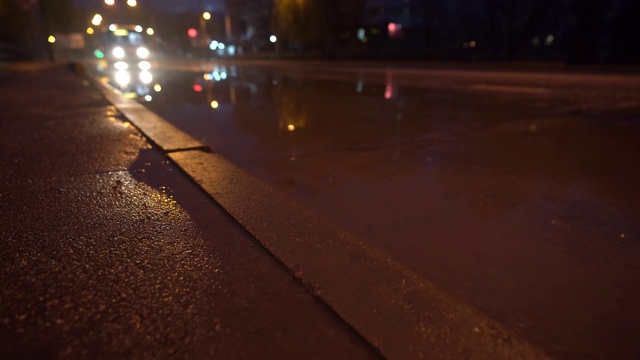 秋雨交加的夜晚，街灯映照在水坑里视频素材