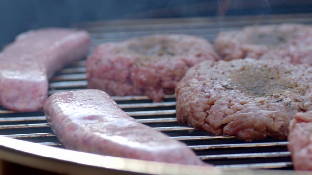 在户外烧烤上烹饪生肉视频素材