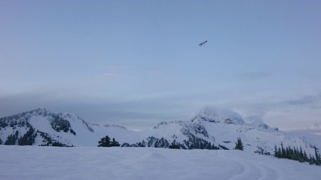 在日落时，飞机飞过白雪覆盖的山脉的镜头——精灵湖，不列颠哥伦比亚省视频素材