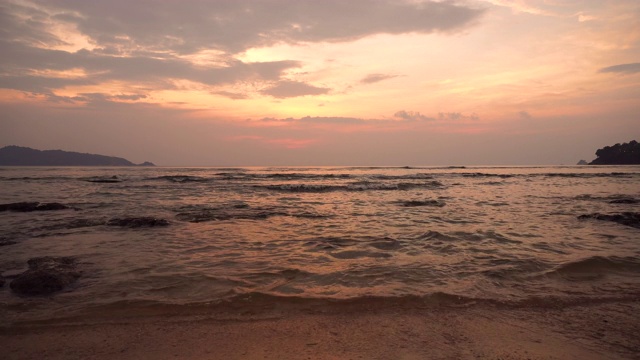 美丽的热带海滩与日落的天空和云的背景。暑假与自然环境理念。视频素材