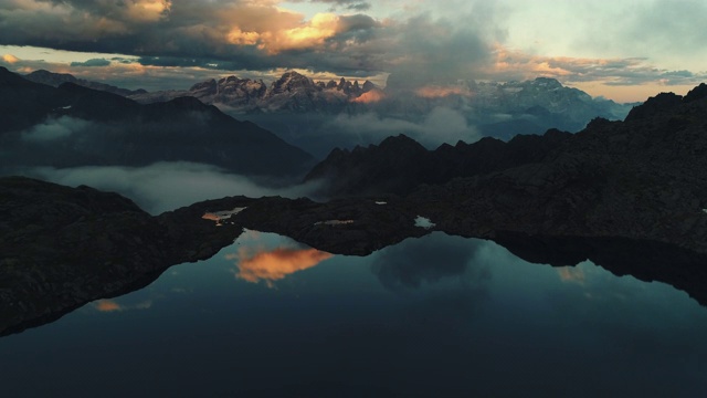 空中摄影展示了一个高海拔的湖和戏剧性的山风景在日落，白云石，意大利视频素材